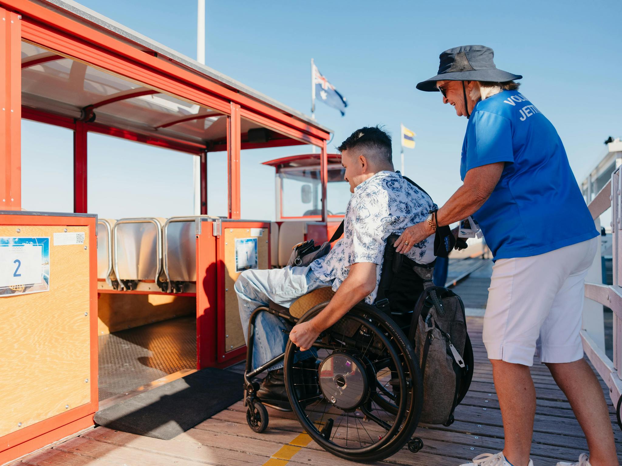 A wheelchair boarding the Jetty Train through it's accessible and widened doors