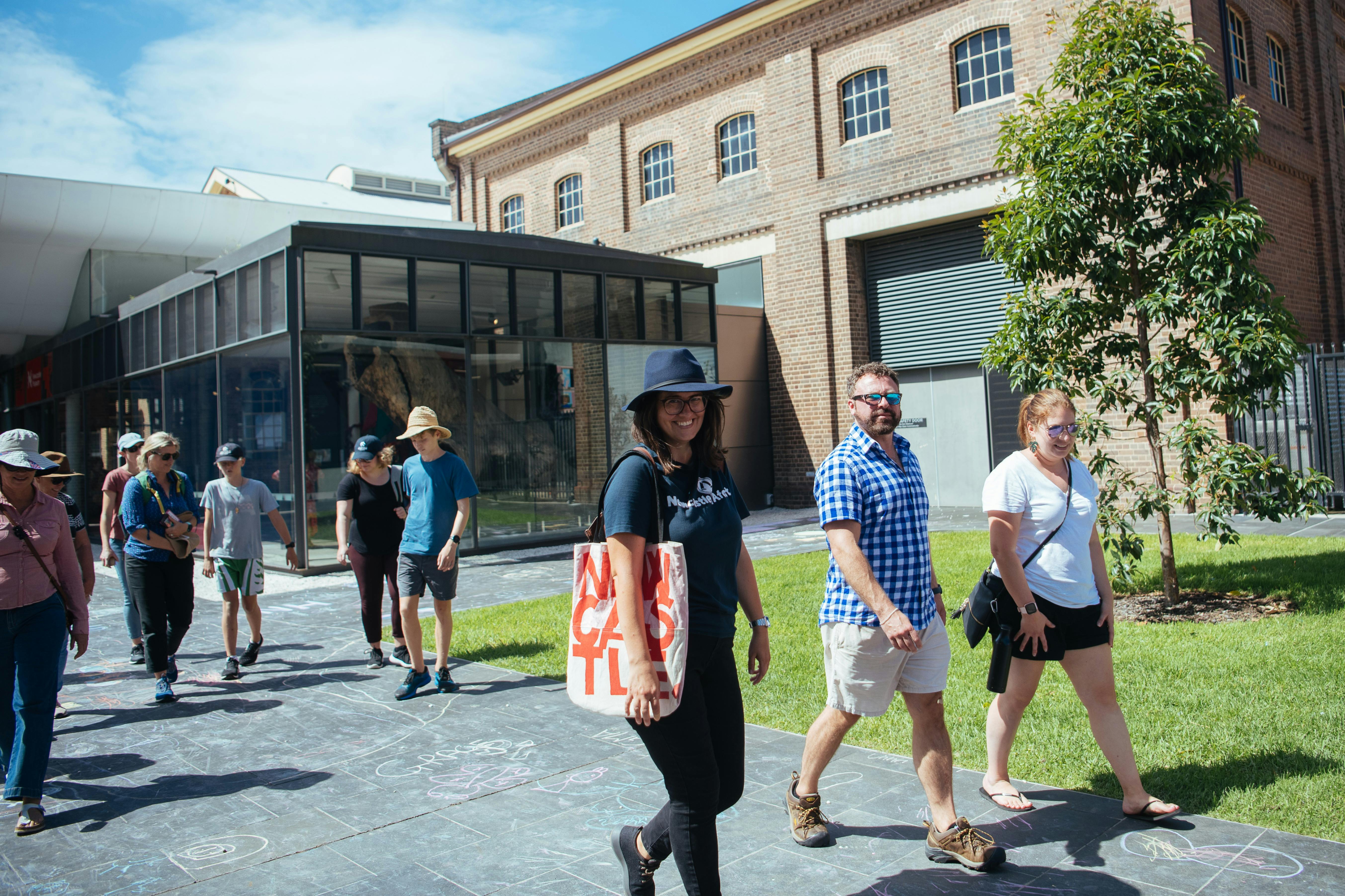 A walking tour group in front of Newcastle Museum on Architecture, Street Art & Hidden Secrets tour