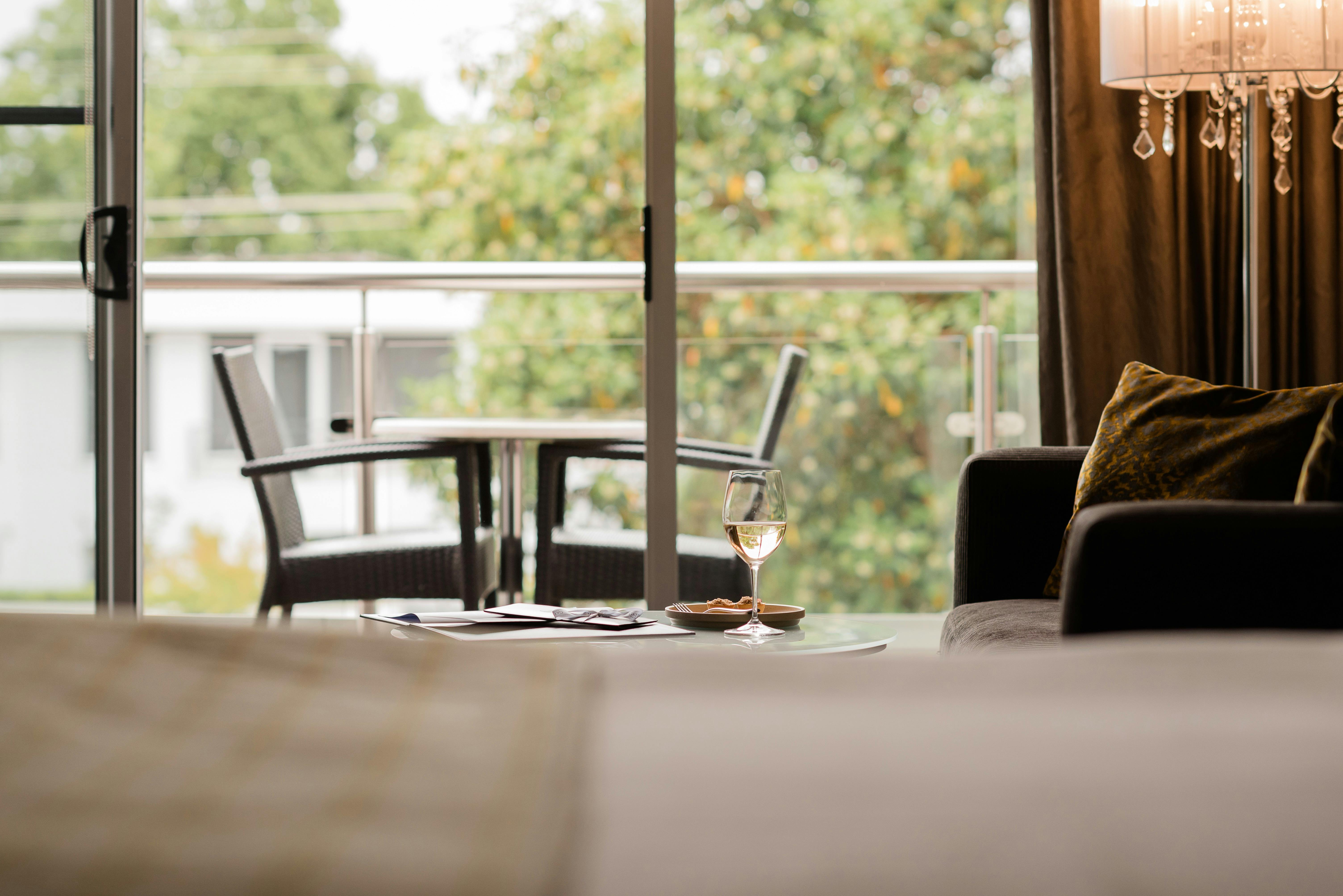 View out to private balcony including dining setting overlooking treetops