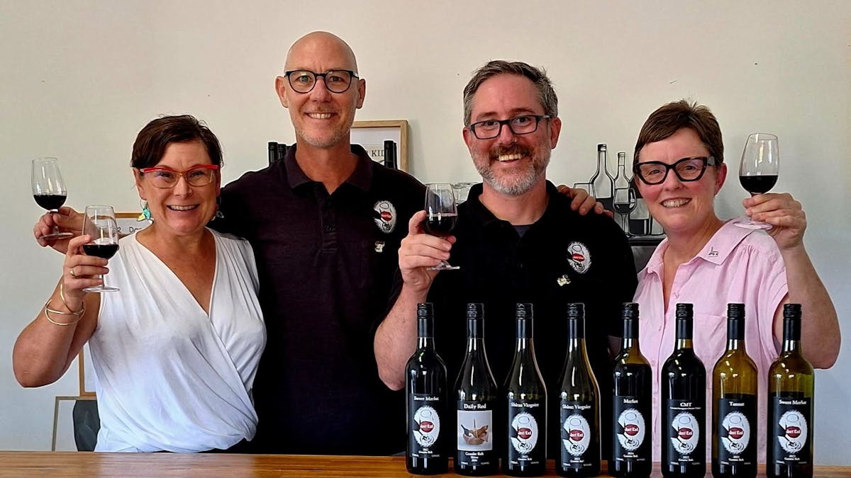 4 People holding up wine glasses in front of their wine varieties
