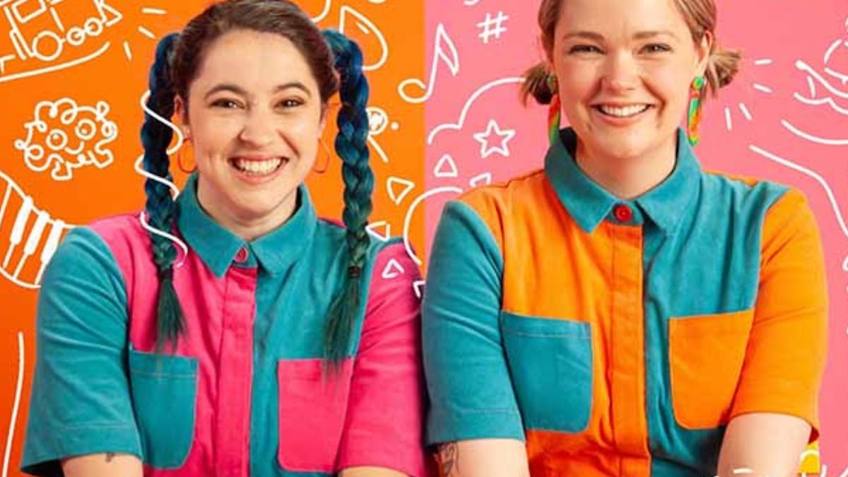 Two adults in bright colour‑block shirts sit before orange and pink scribble backgrounds.