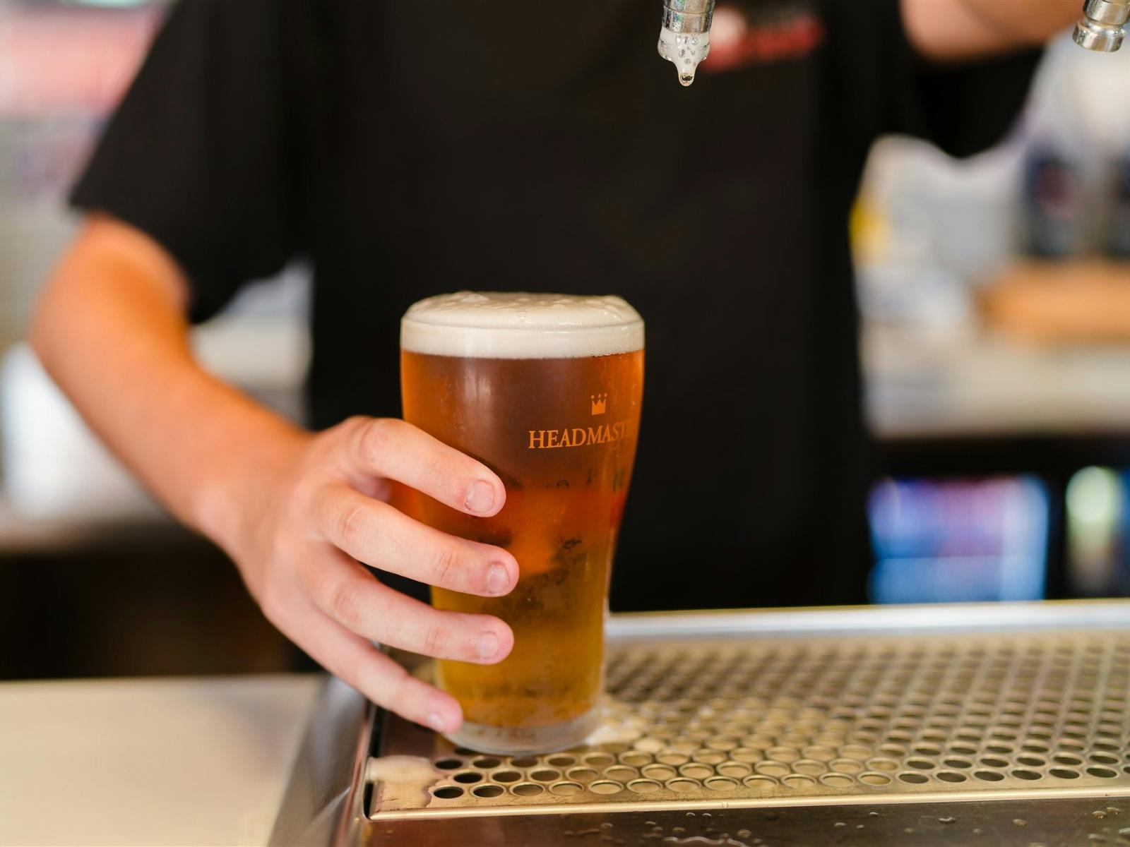 Staff member pouring a beer at Top Town Tavern