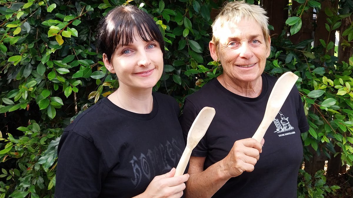 two people holding wooden spoons