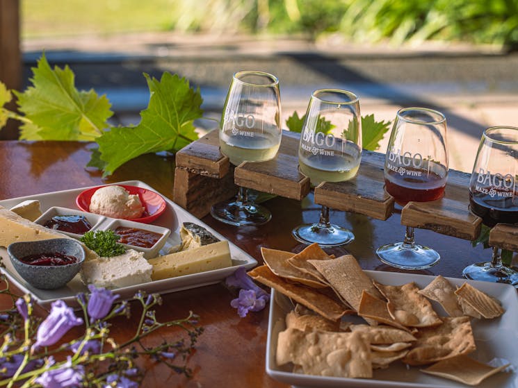 Enjoy Bagos wine tasting paddle with a platter of locally sourced cheeses