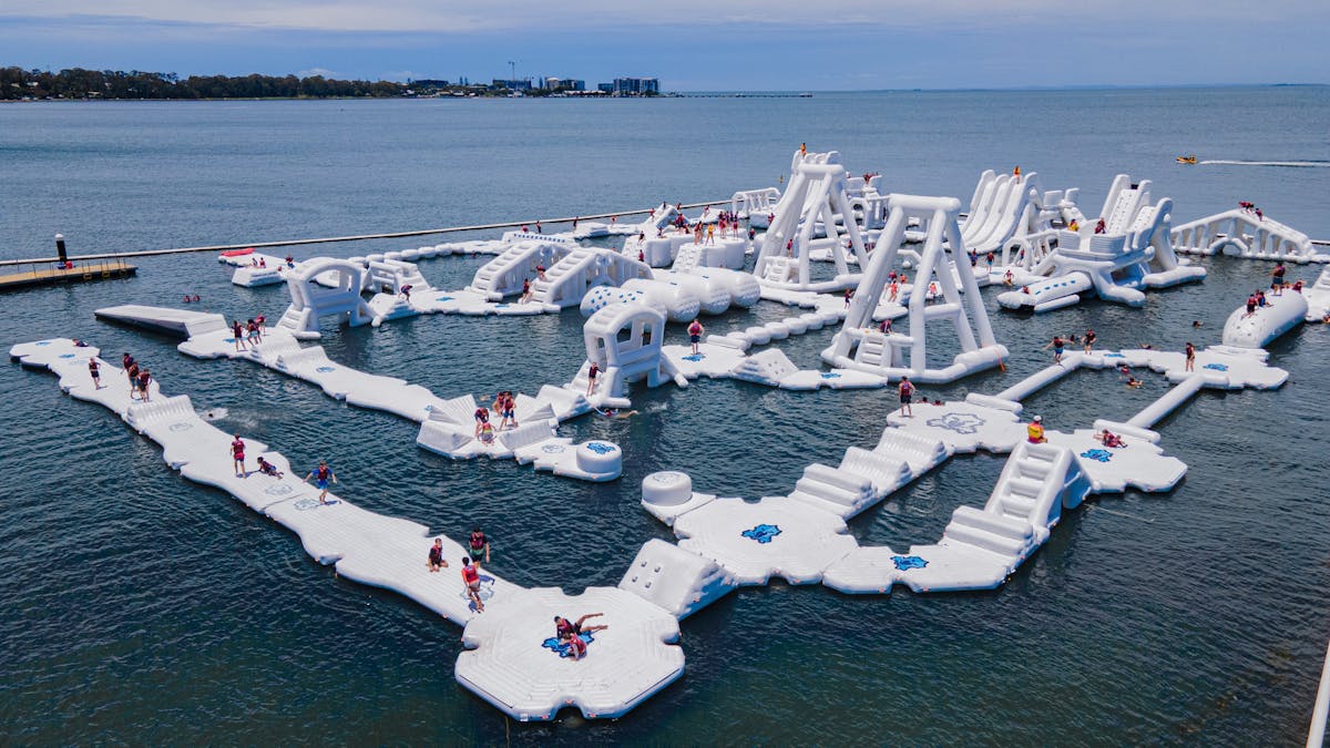 Ariel shot of inflatable aqua park with people on it