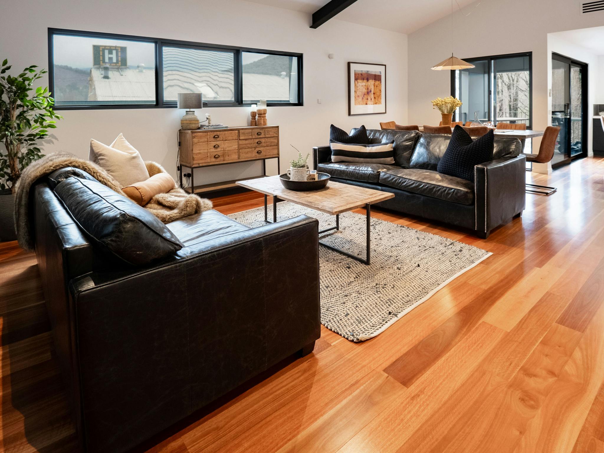 Olsen Penthouse living room couches, tea tables and windows