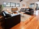 Olsen Penthouse living room couches, tea tables and windows