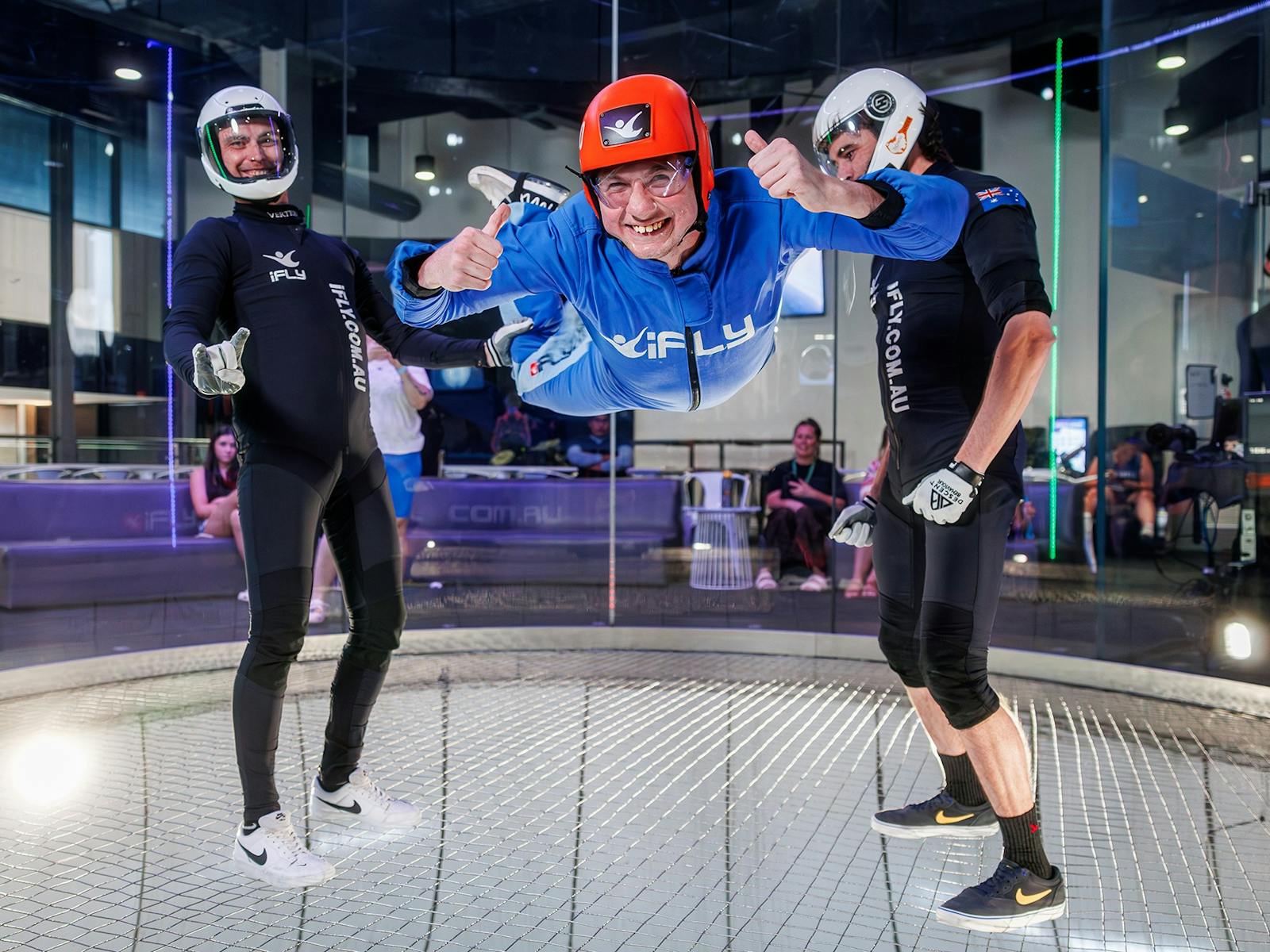 Flyer in a blue suits gives a thumbs up to the camera