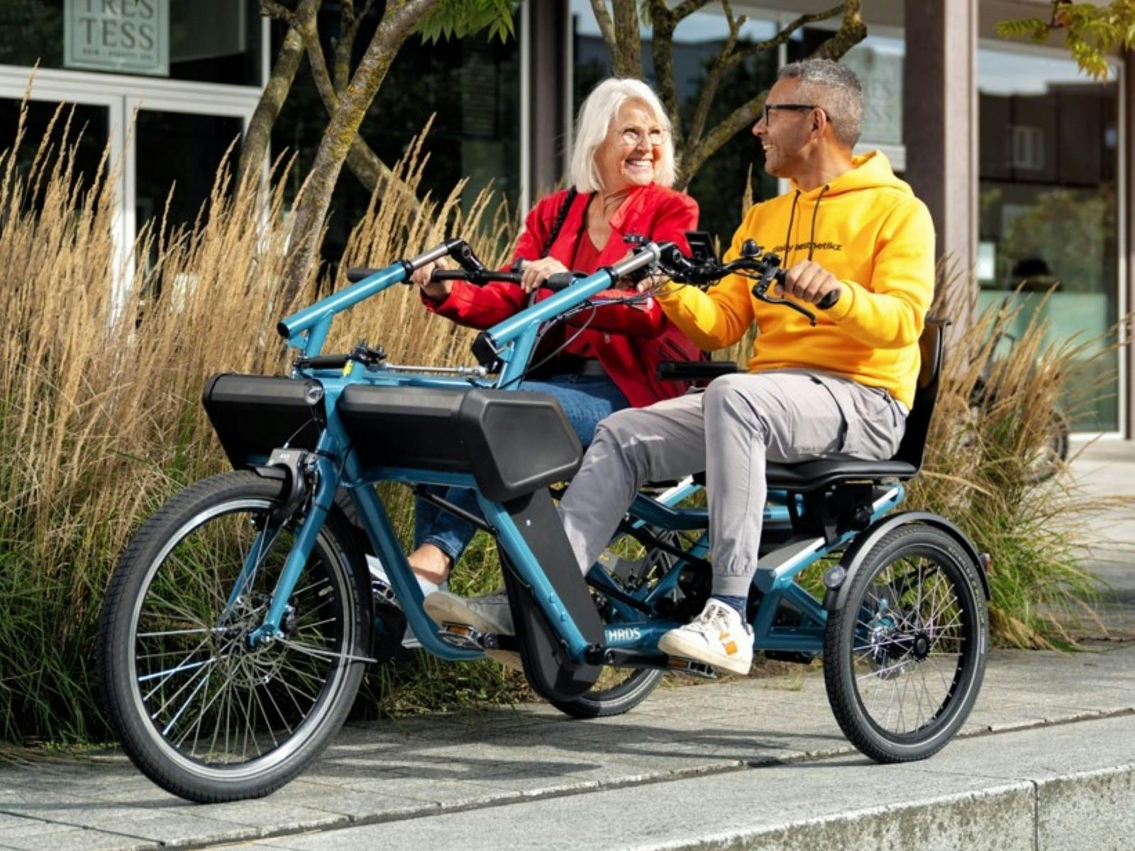2 people riding side by side on electric trike 2 people riding side by side on electric trike