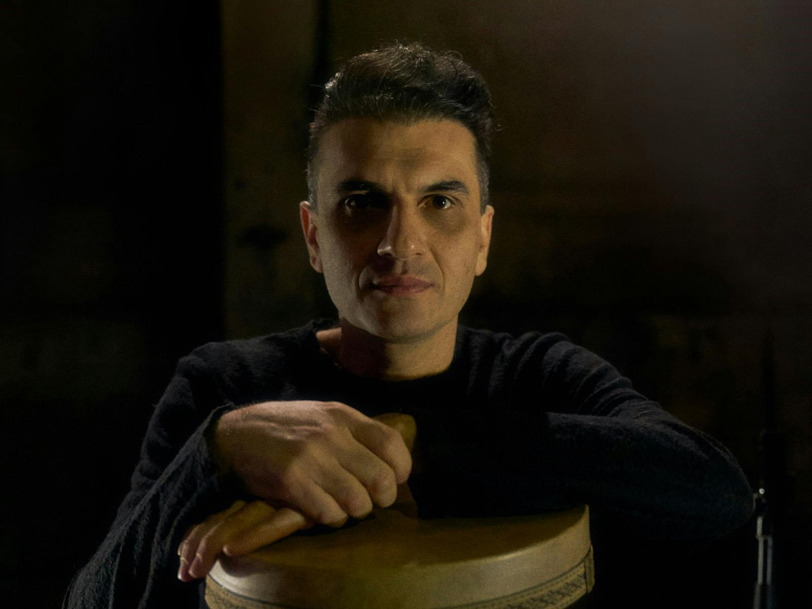 Mohammad Reza Mortazavi leaning on bongo