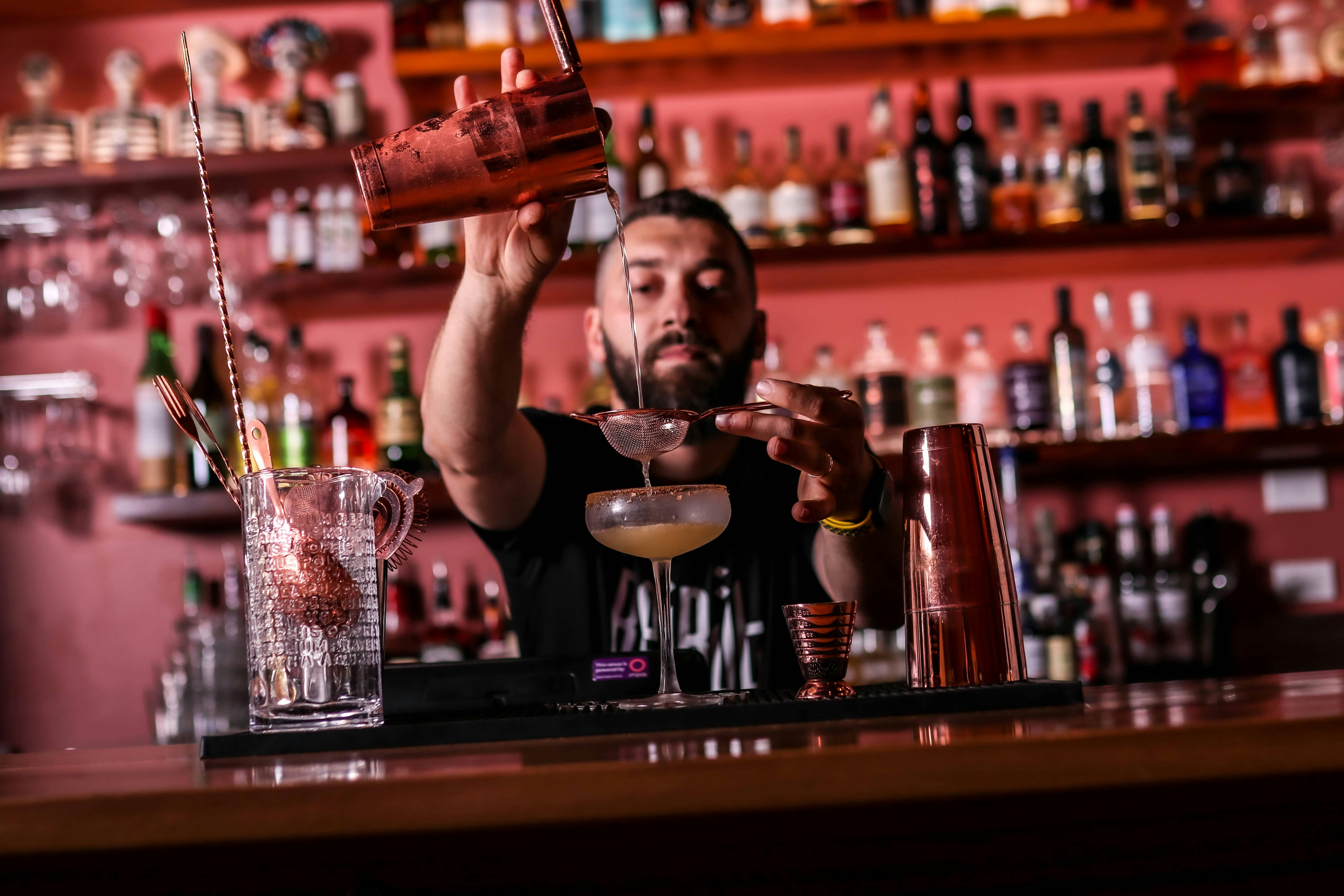 Bartender pouring a cocktail