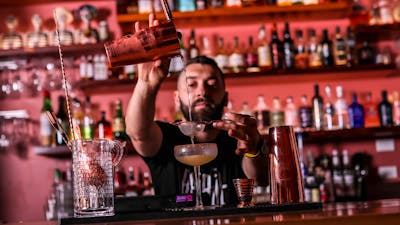 Bartender pouring a cocktail
