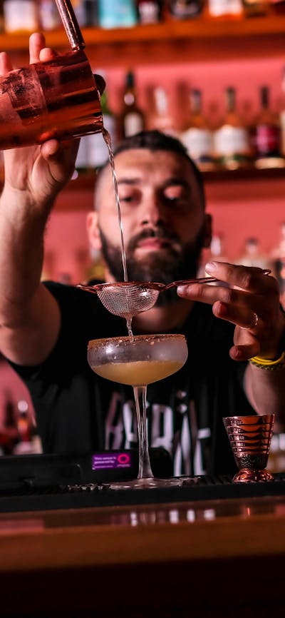 Bartender pouring a cocktail