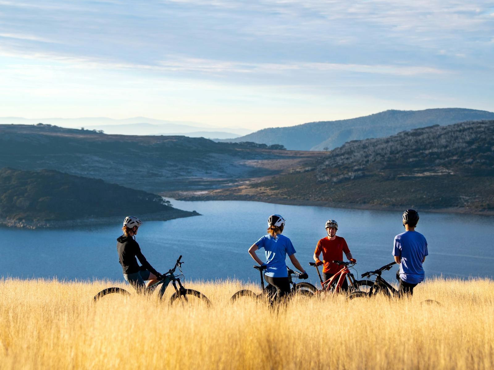 A group of cyclists by Rocky Valley Lake at Falls Creek in the green season