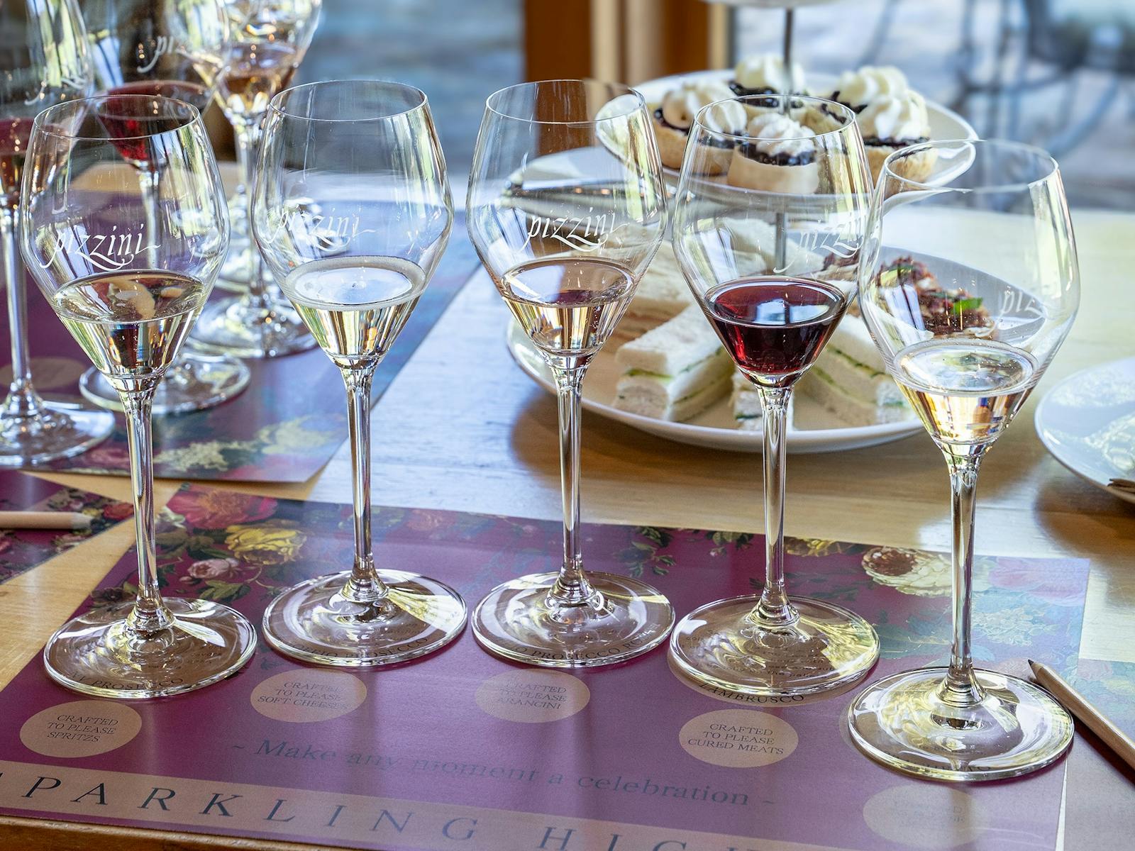 Pizzini Wine in five glasses placed on the table