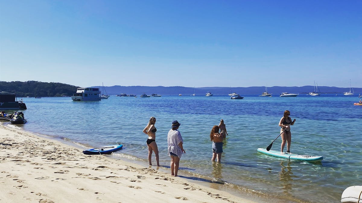 Stand-up paddle boarding in Horsehoe Bay, Moreton Bay with Brisbane Yacht Charters