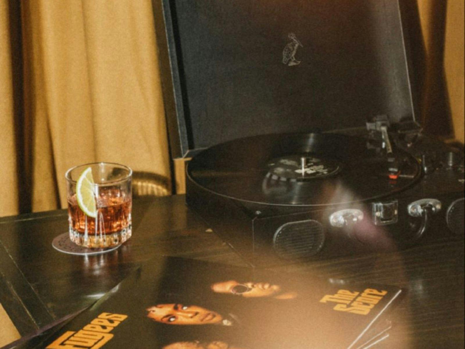 Record player and drink on timber table