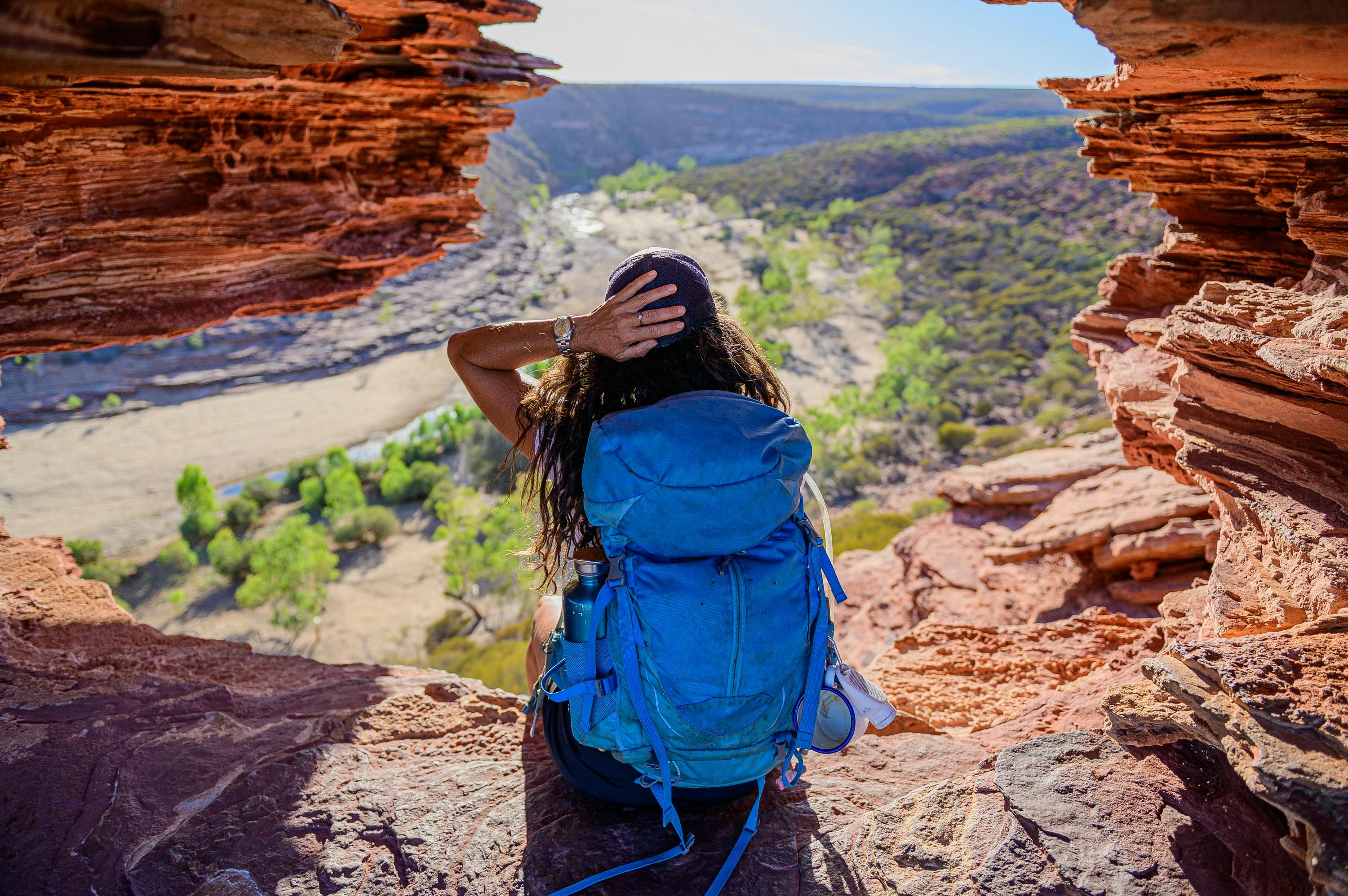 Erika looking over the river from sandstone gap in the wall