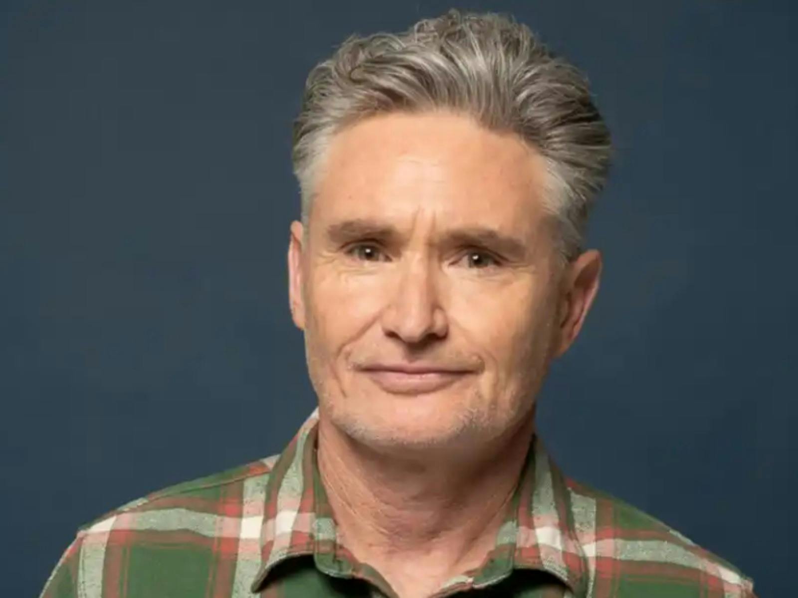 a portrait of Dave Hughes on a dark blue background