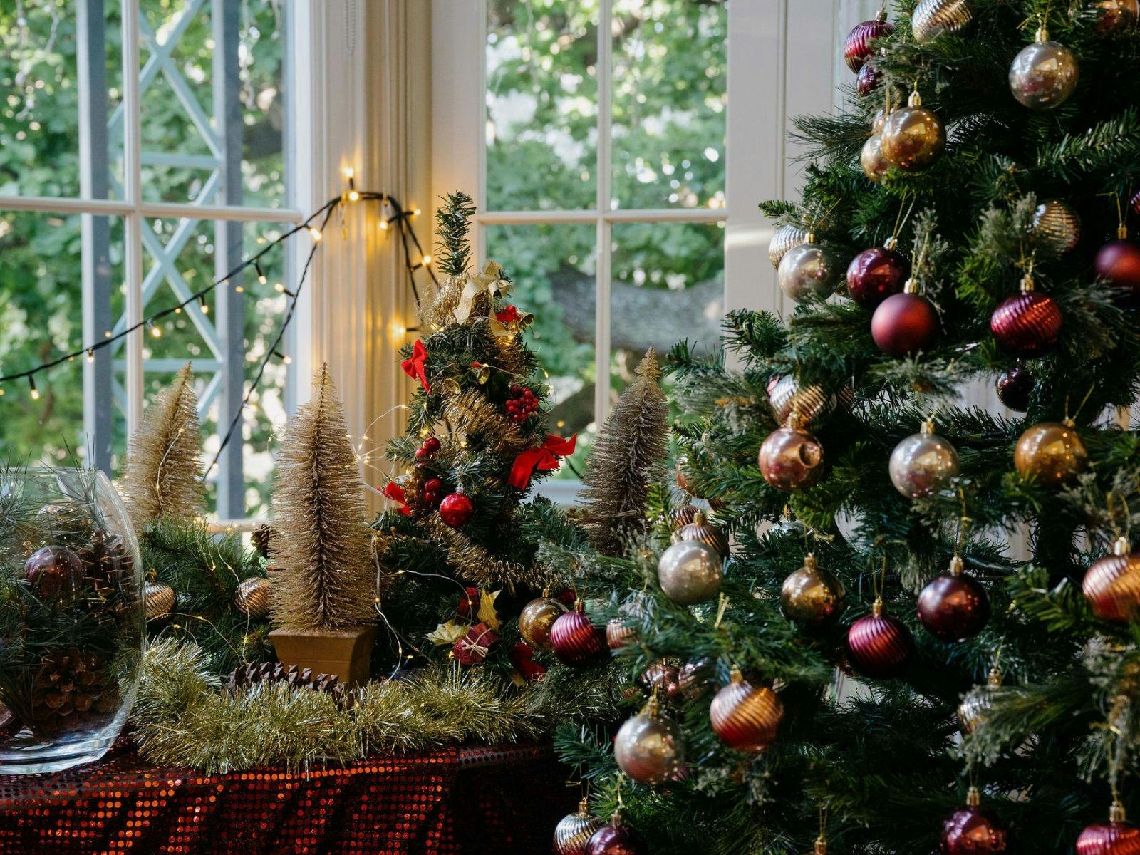 A christmas tree, baubles, mini christmas trees and decorations