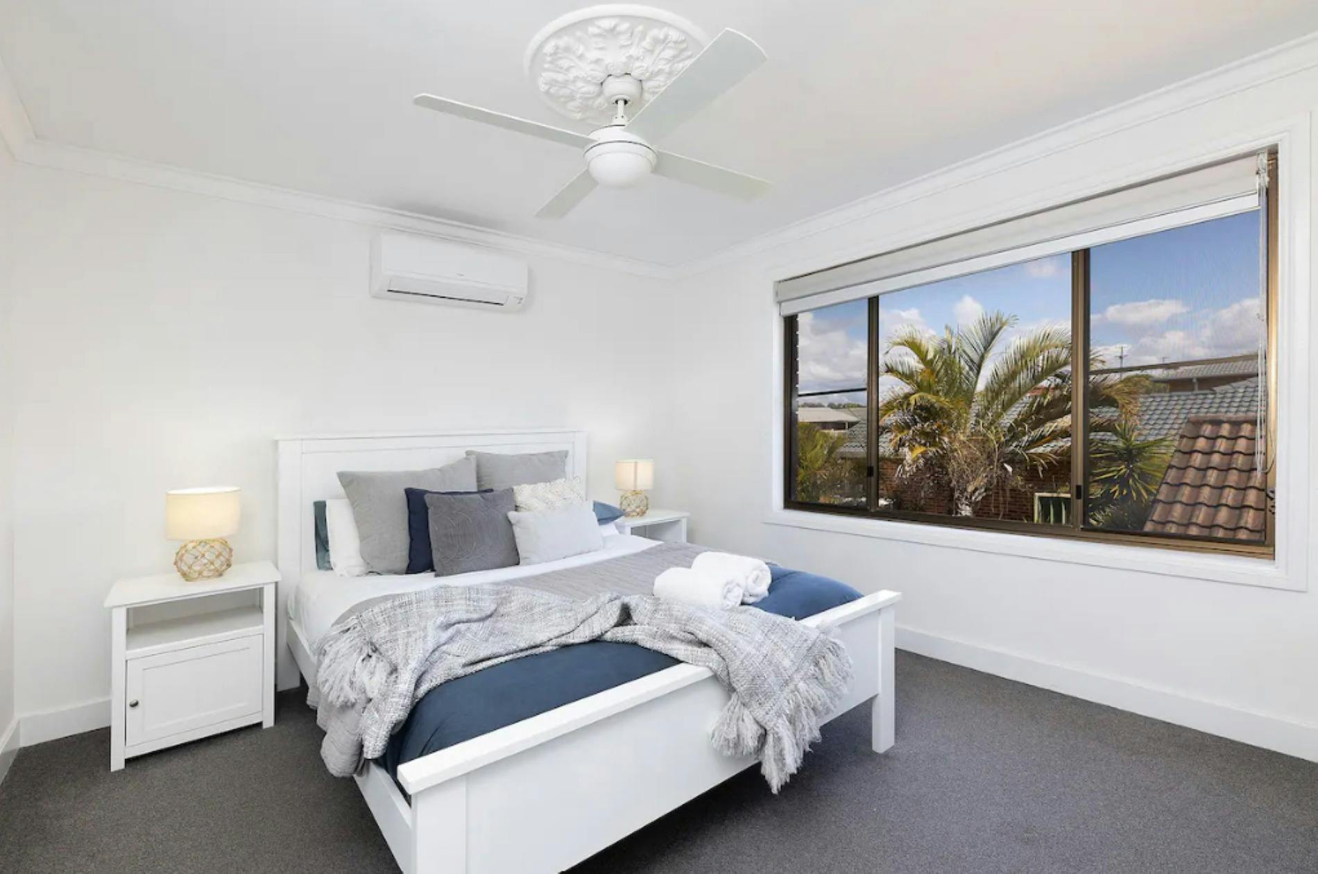 Bedroom with ceiling fan a nd air-conditioning