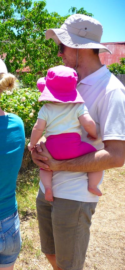 Two adults and two children looking at information panel outdoors