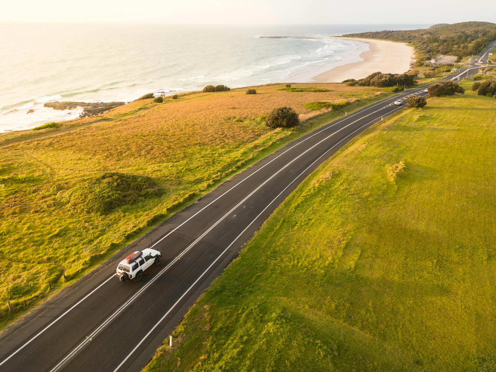 Car driving South on the Coast Road with Sharpes Beach