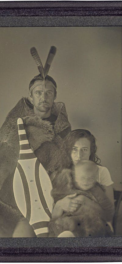 A leather case displaying Grey Kangaroo fur beside a greyscale photograph of a family.