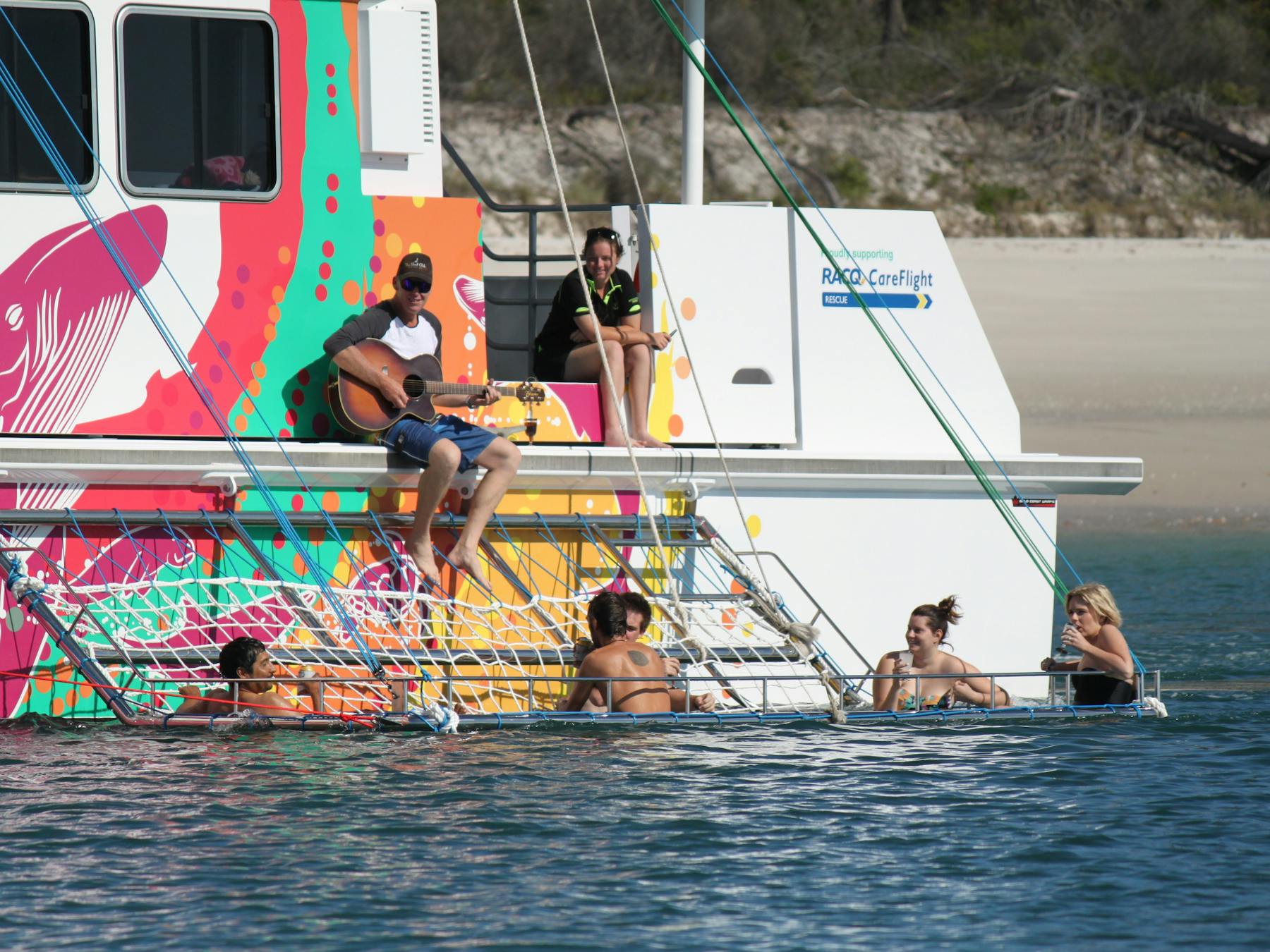 BOOMNET relax drink as we slowly cruise beside K'gari (Fraser) Island