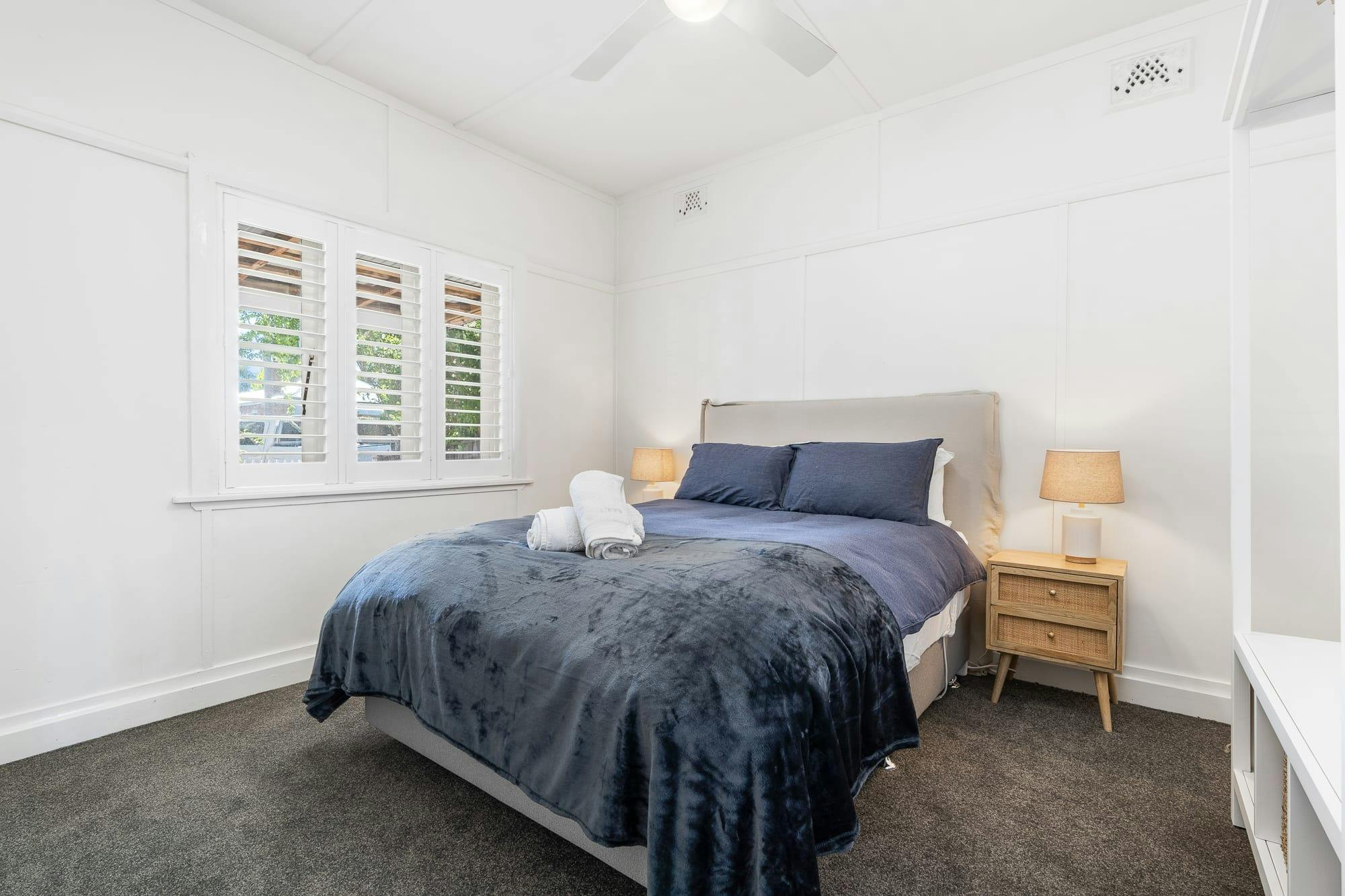 Queen Bed with window and side tables