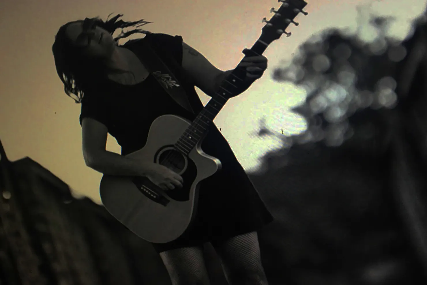 Amanda Emblem playing guitar