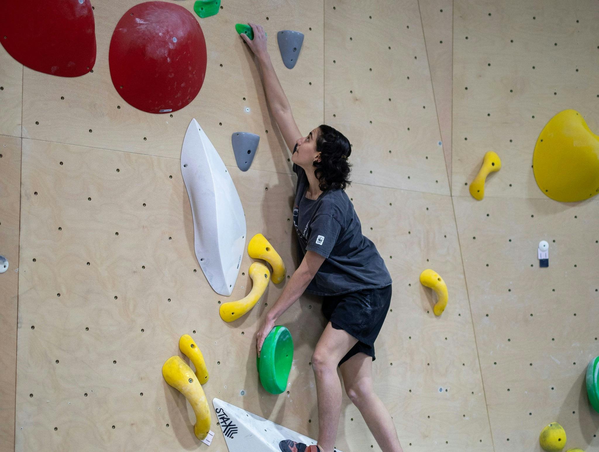 Someone on the climbing wall at Nomad Bouldering