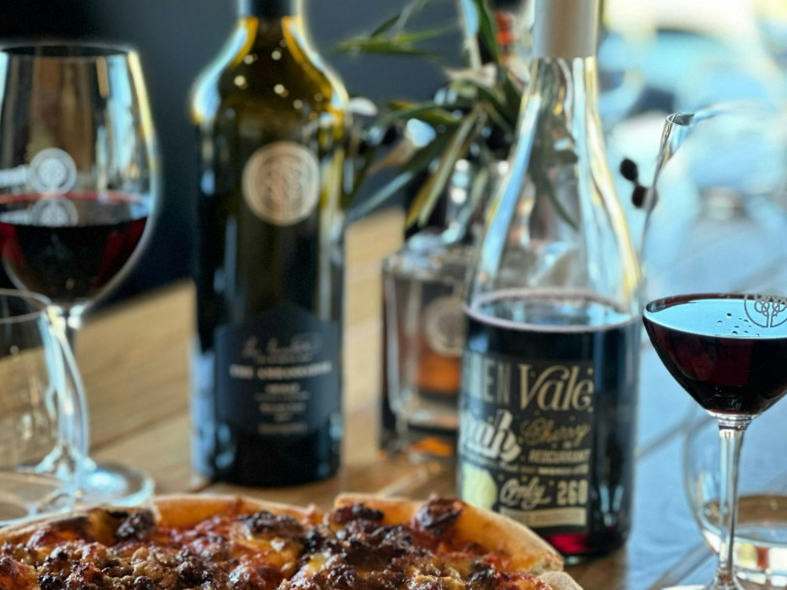 Hand stretched pizzas with wine