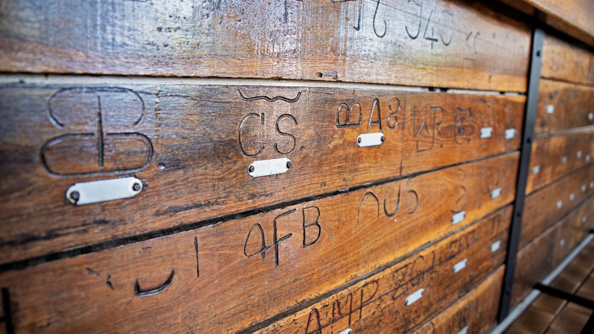 View the local grazier's brands scorched into the timber bar.
