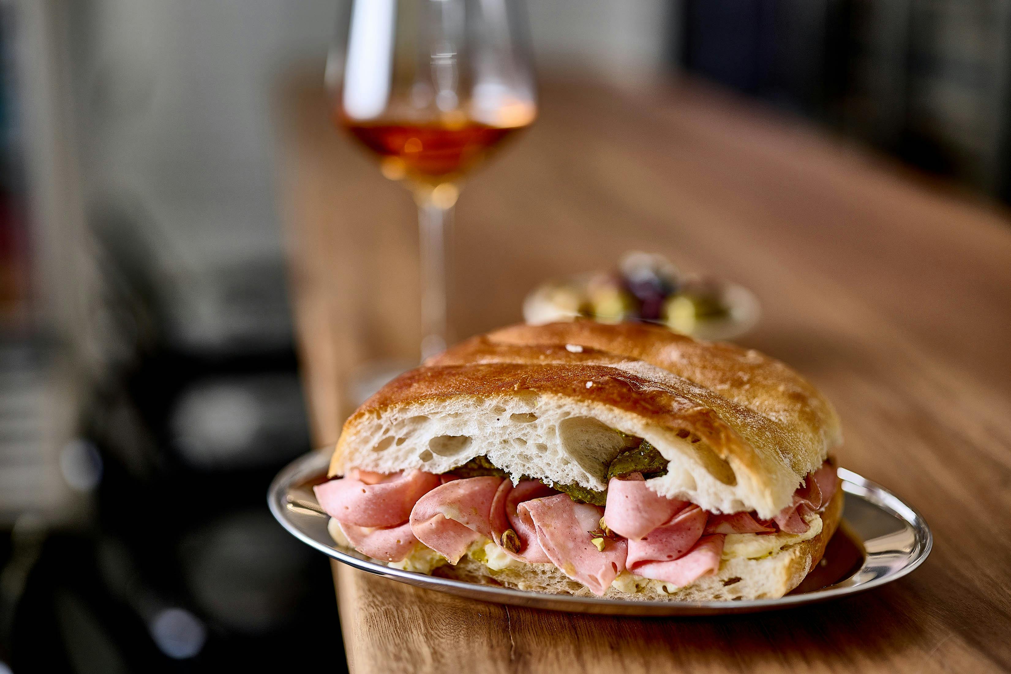 Panini with mortadella and a glass of wine
