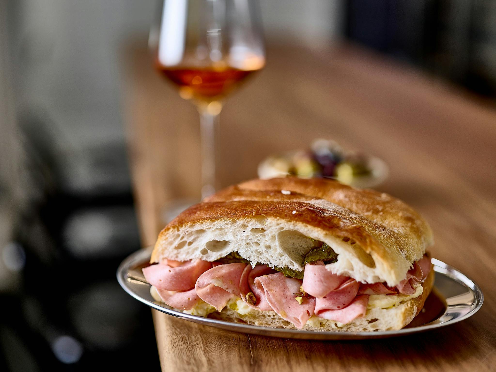 Panini with mortadella and a glass of wine