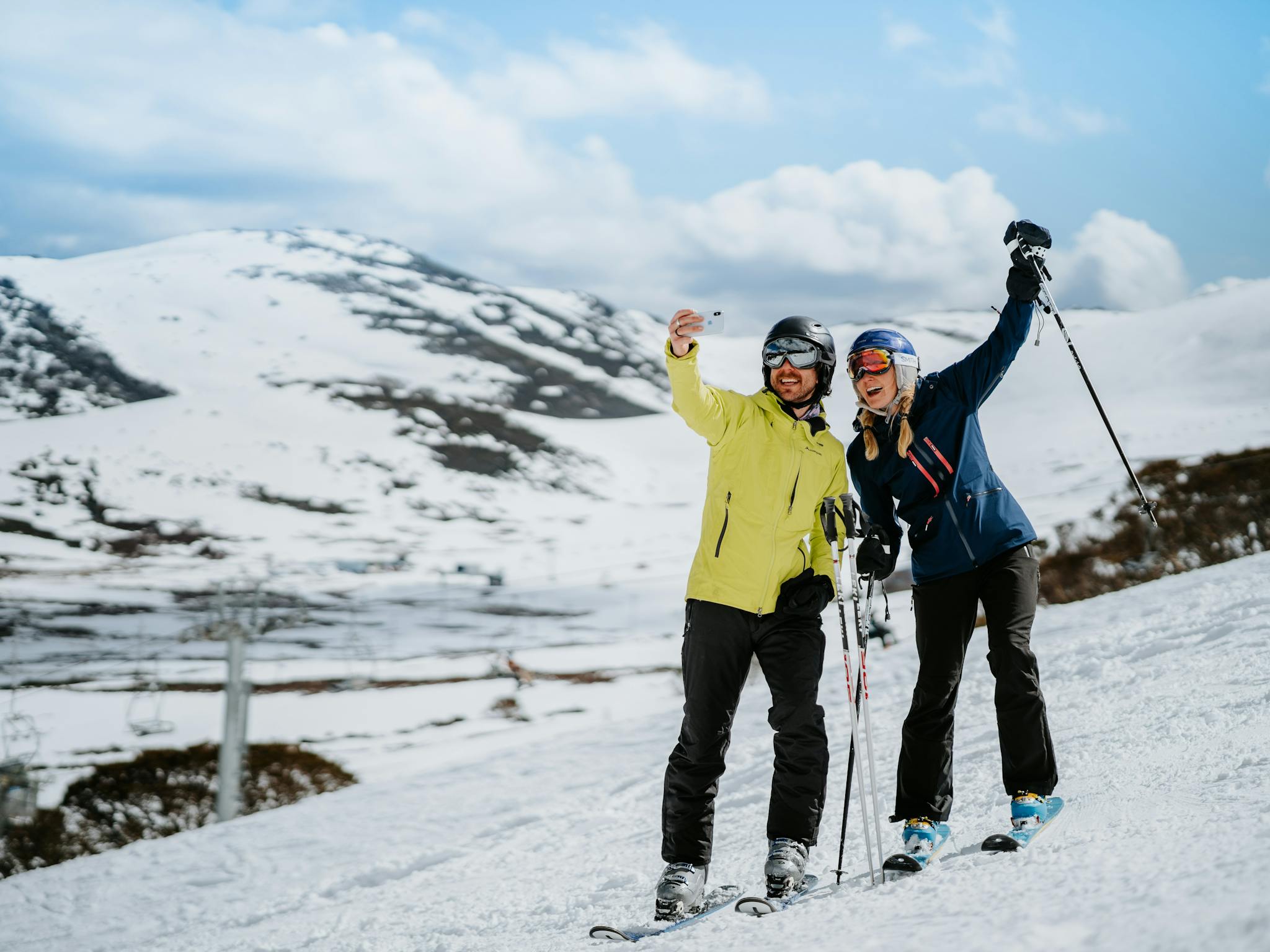 Two skiers posing for a happy photo on the slopes at Falls Creek