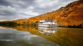 Proud Mary cruising next to cliffs
