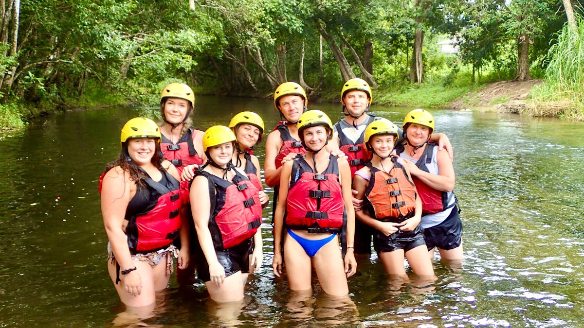 Large Family posing in safety gear ready to tube down the Little Mulgrave River near Cairns