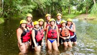 Large Family posing in safety gear ready to tube down the Little Mulgrave River near Cairns