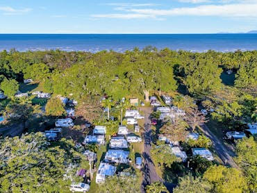 Image showing a full Resort with Caravans, Camping and Motorhomes from above. Beach in the distance