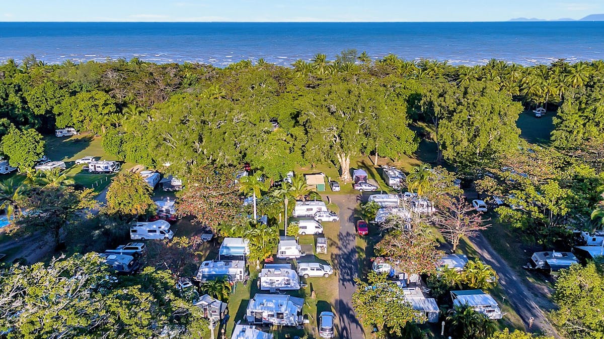 Image showing a full Resort with Caravans, Camping and Motorhomes from above. Beach in the distance