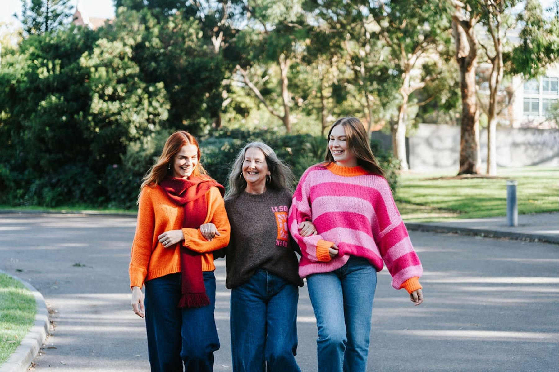 Three women wearing winter jumpers