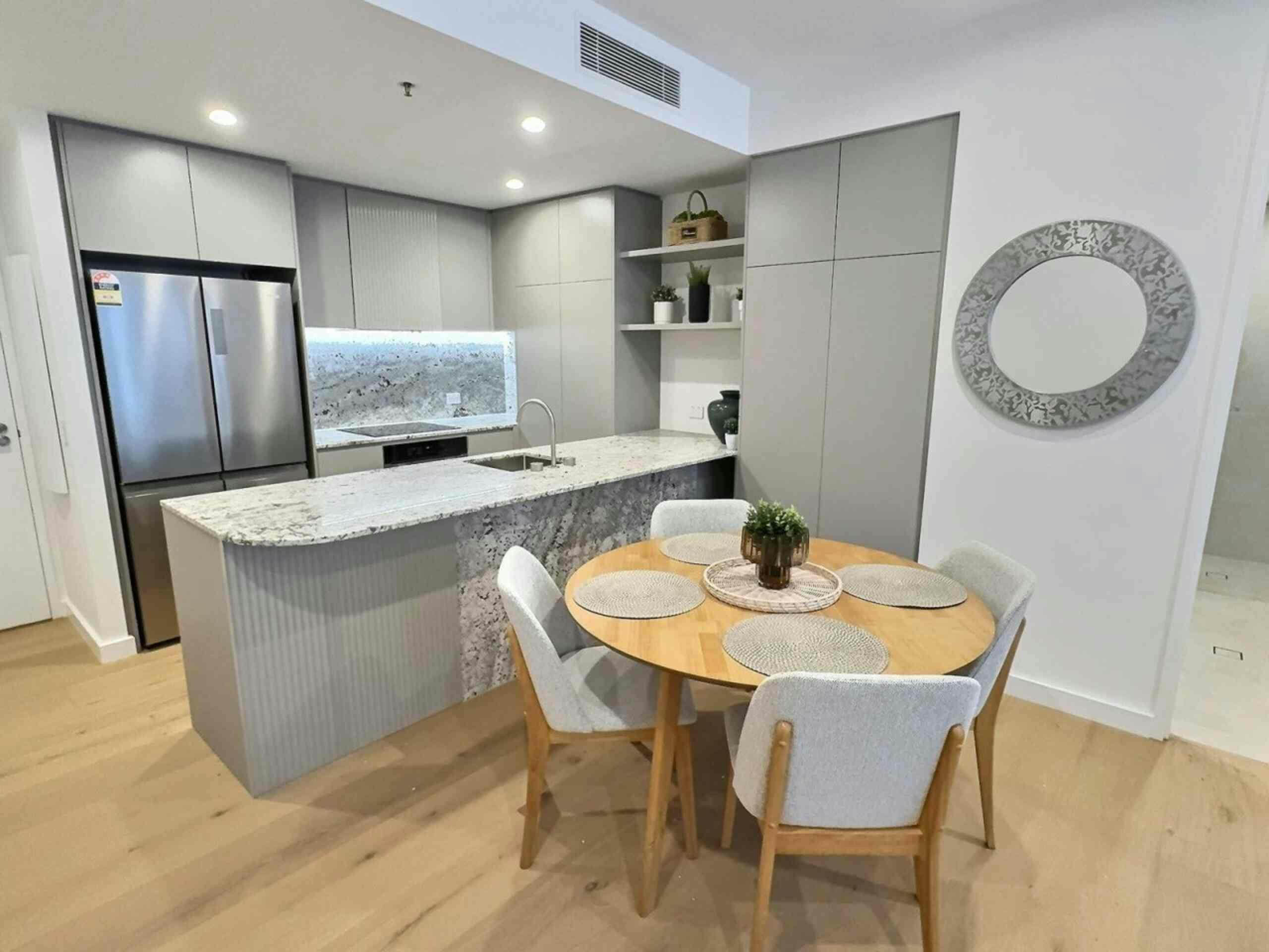 Close-up of a kitchen island counter paired with a wooden dining table setup.