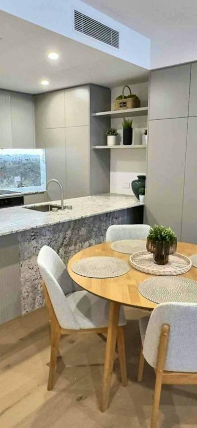 Close-up of a kitchen island counter paired with a wooden dining table setup.