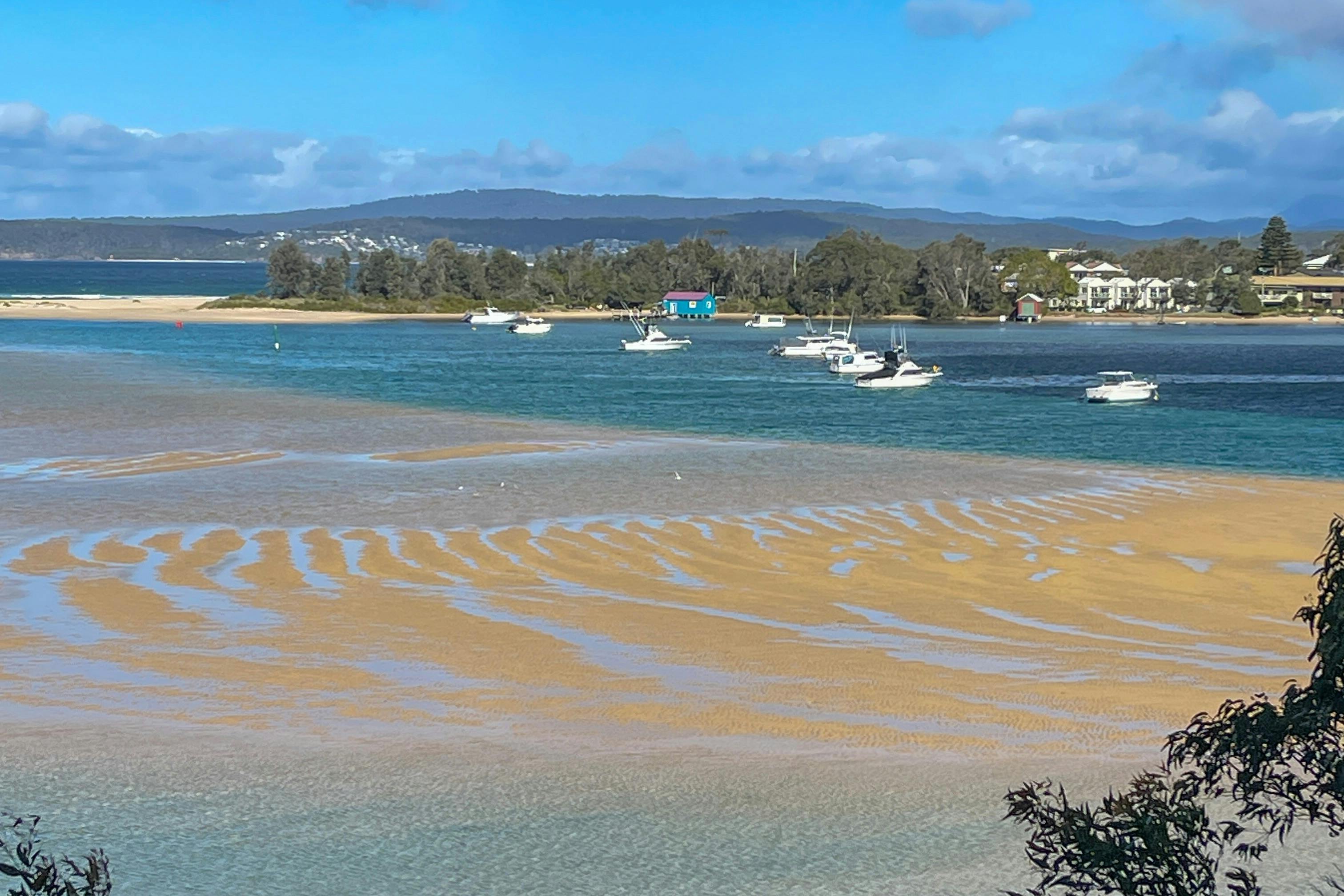 View facing south across Merimbula Lake at low tide.