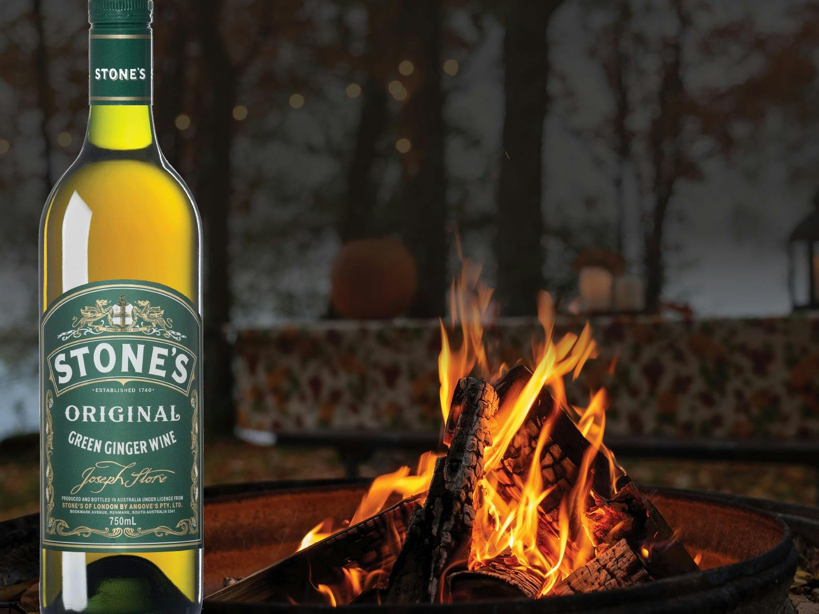 Bottle of Stone's Green Ginger wine by a fire