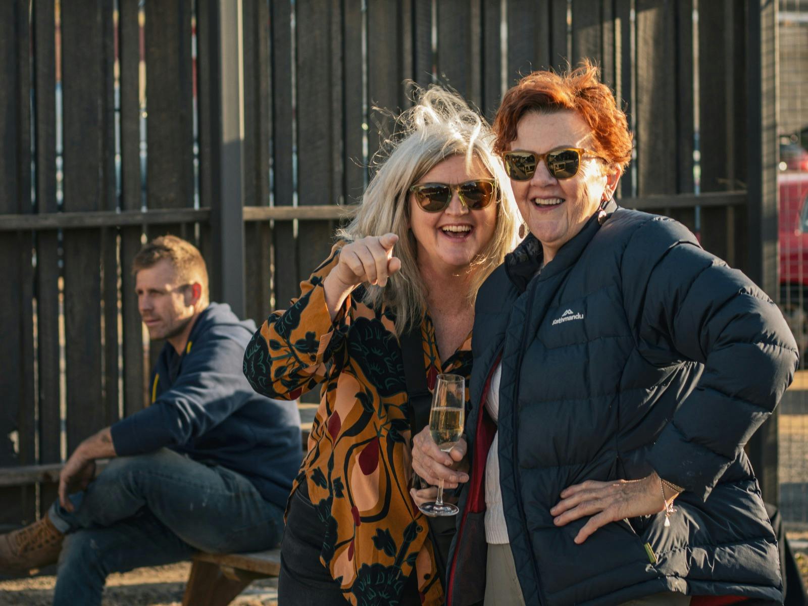 Two women smiling together in the Easy Tiger yard in St Helens.