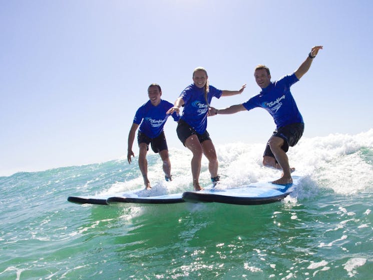 Three people surfing