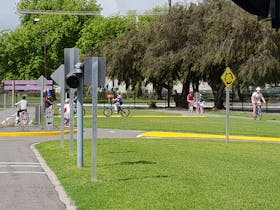 Children riding their bikes along little roads at Millicent Road Safety School.